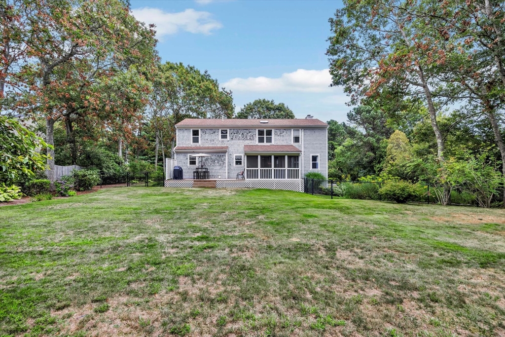 19 Drew Lane Mashpee, MA 02649 - Photo 6 of 42 a view of a big house with a big yard and large trees