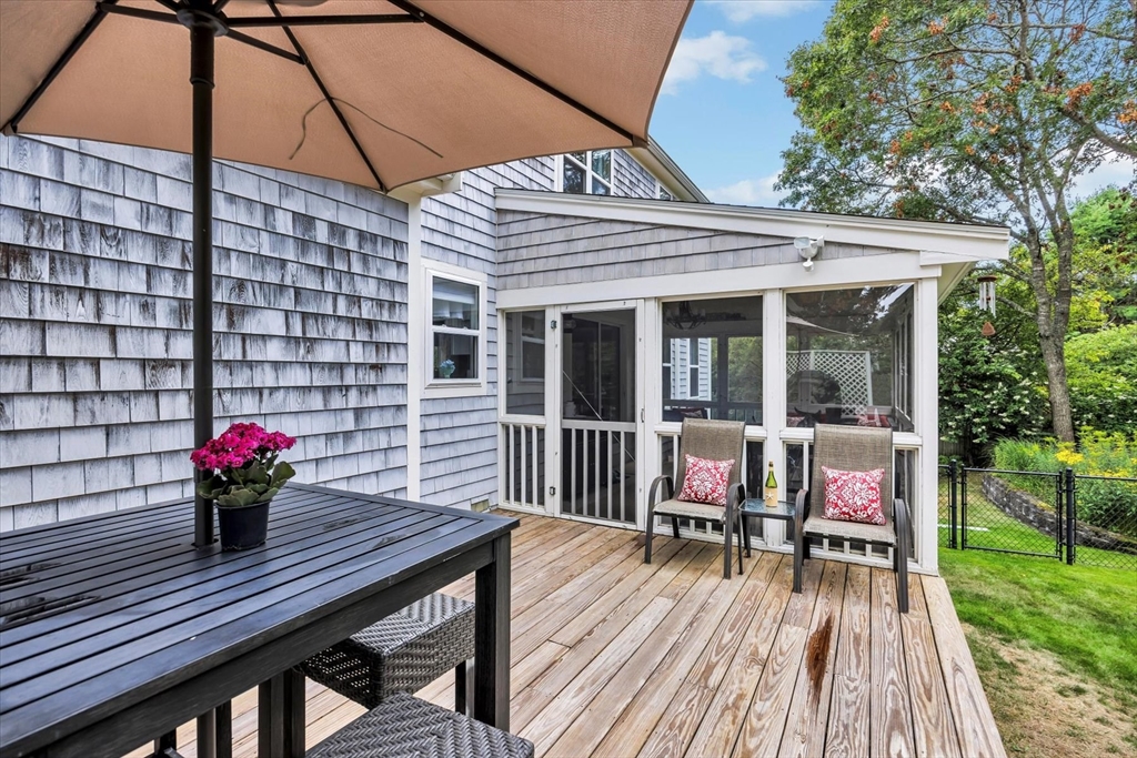 19 Drew Lane Mashpee, MA 02649 - Photo 8 of 42 a view of a wooden chairs and table in the patio
