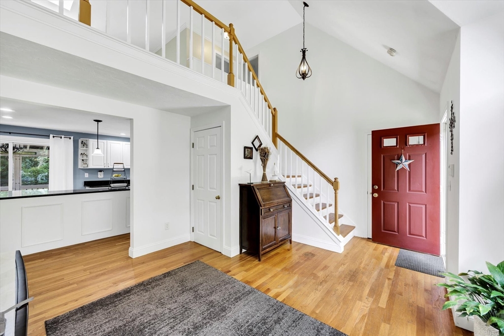 19 Drew Lane Mashpee, MA 02649 - Photo 9 of 42 a view of a livingroom with wooden floor and stairs