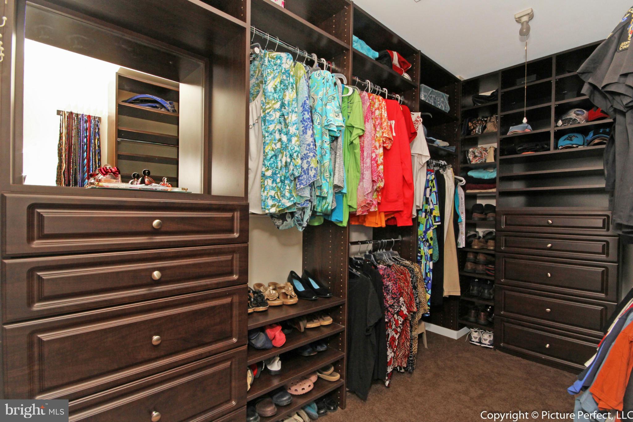 14308 Autumn Crest Road Boyds, MD 20841 - Photo 11 of 21 a view of walk in closet with clothes and shoes