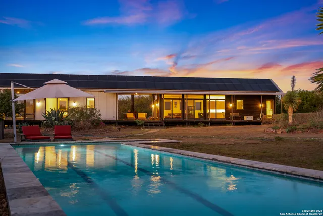 swimming pool view with a seating space