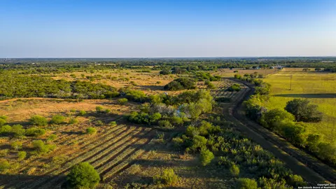 a view of a lake with a table and chairs