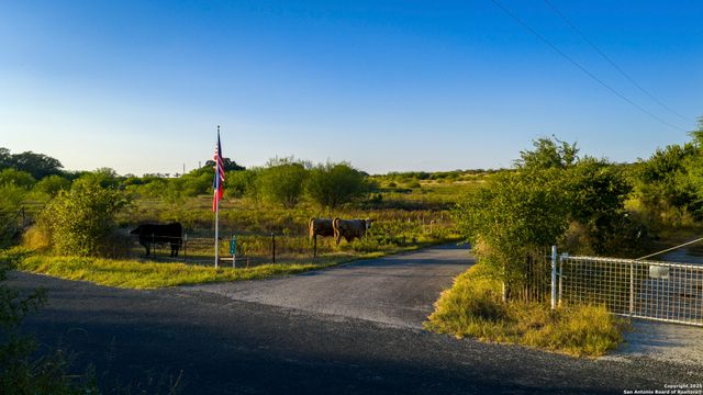 a view of swimming pool with a table and chairs under an umbrella