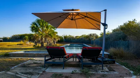 a backyard of a house with table and chairs