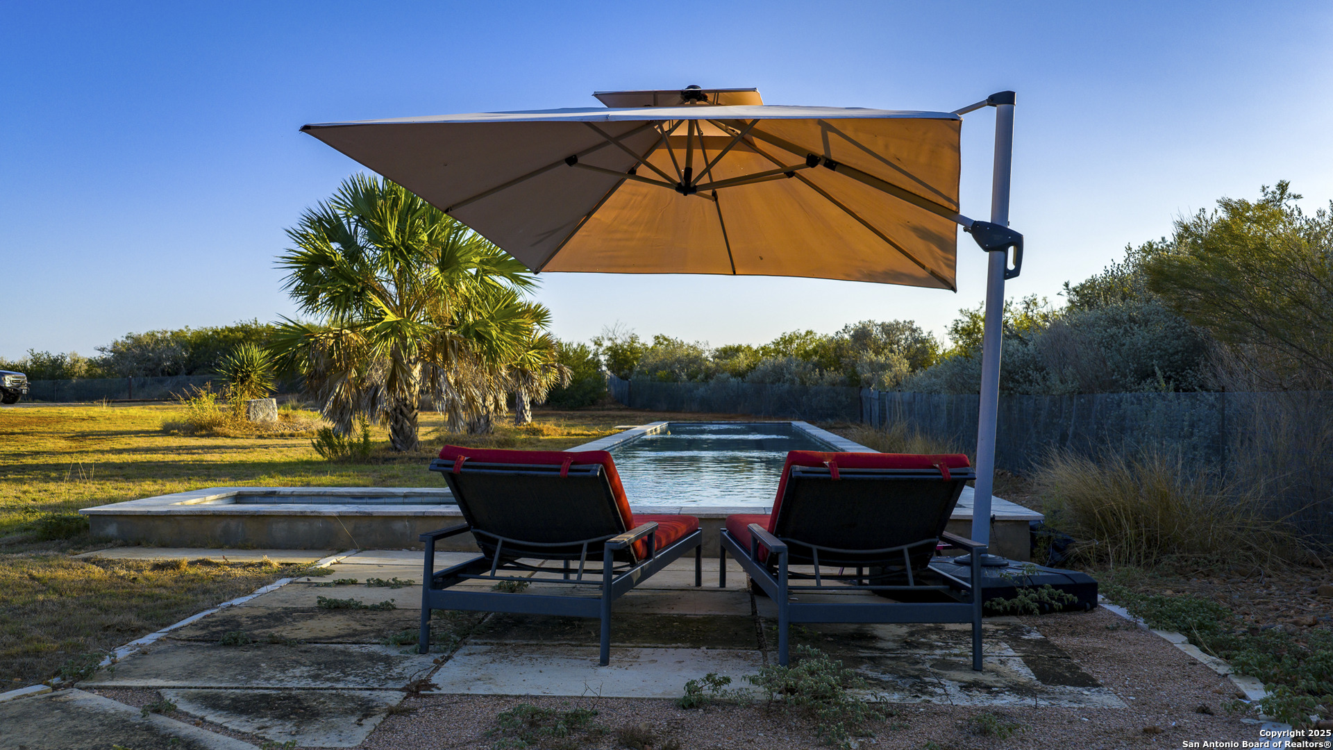 514 County Road 669 Devine, TX 78016 - Photo 23 of 45 a view of swimming pool with a table and chairs under an umbrella