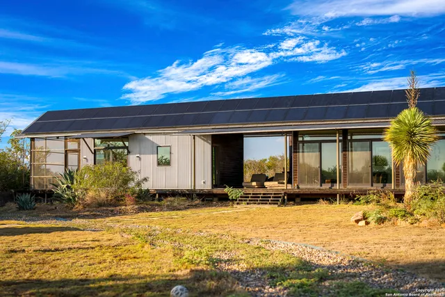 a kitchen with stainless steel appliances granite countertop a sink a stove and a microwave