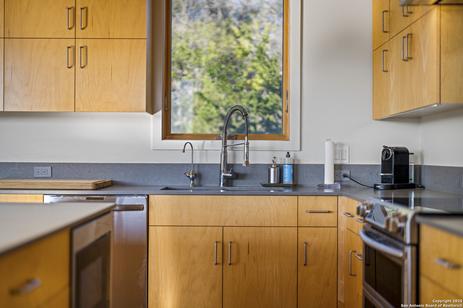 514 County Road 669 Devine, TX 78016 - Photo 32 of 45 a kitchen with stainless steel appliances granite countertop a sink a stove and a microwave