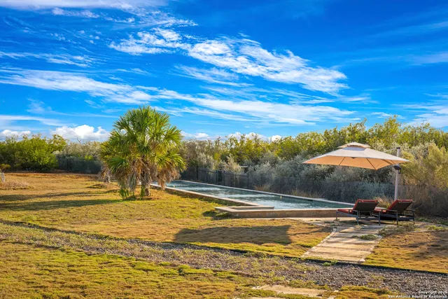 a bathroom with a granite countertop sink a toilet a mirror and shower