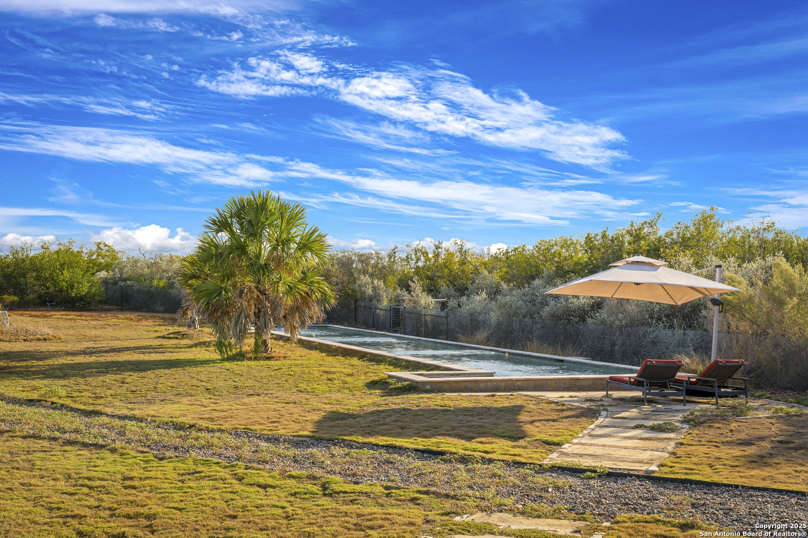 514 County Road 669 Devine, TX 78016 - Photo 34 of 45 a view of a swimming pool with an outdoor space and seating area