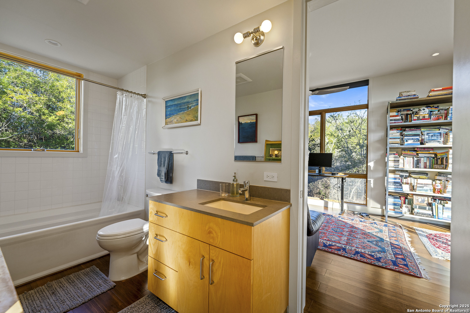 514 County Road 669 Devine, TX 78016 - Photo 36 of 45 a bathroom with a granite countertop sink a toilet a mirror and shower