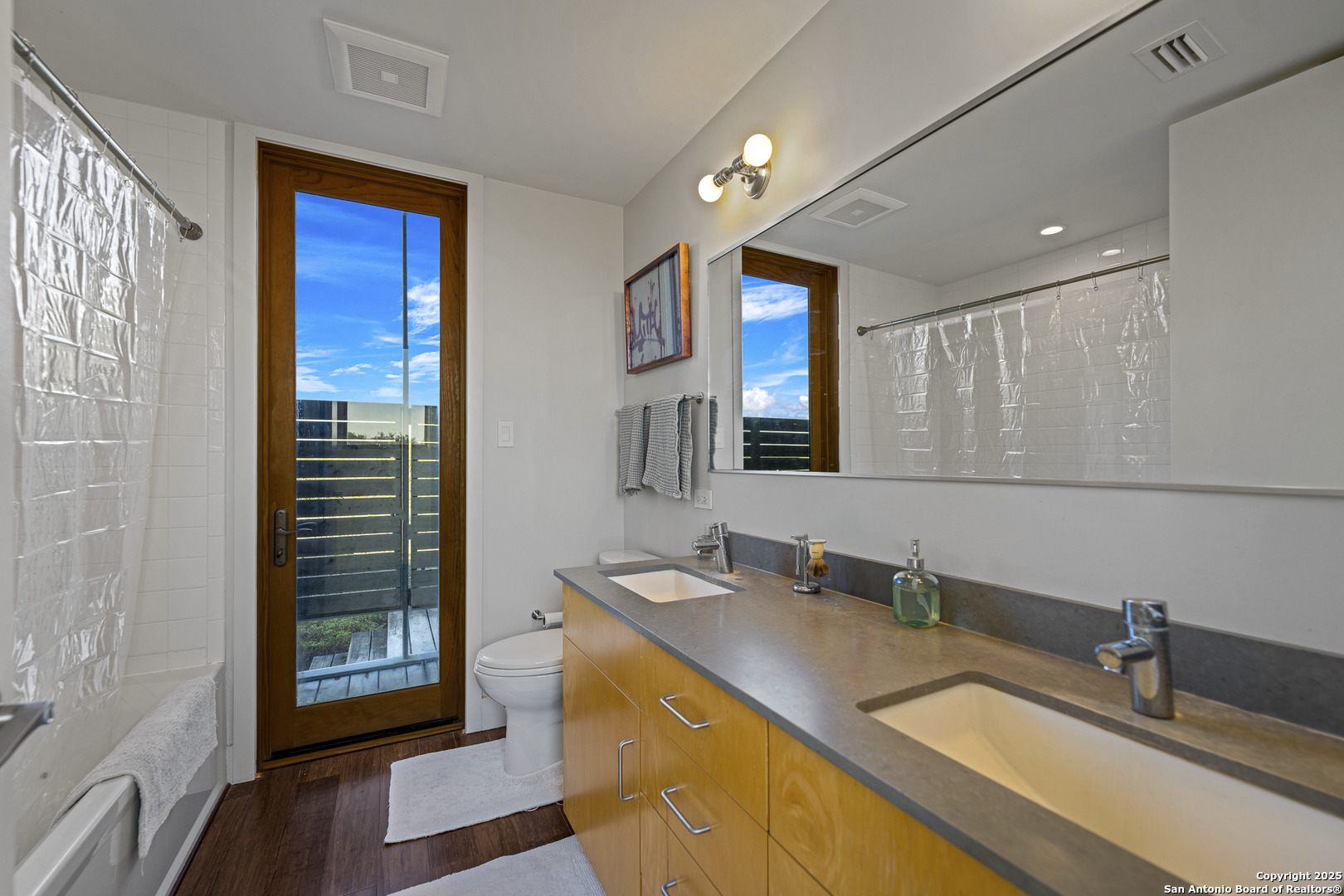 514 County Road 669 Devine, TX 78016 - Photo 40 of 45 a bathroom with a double vanity sink and a mirror