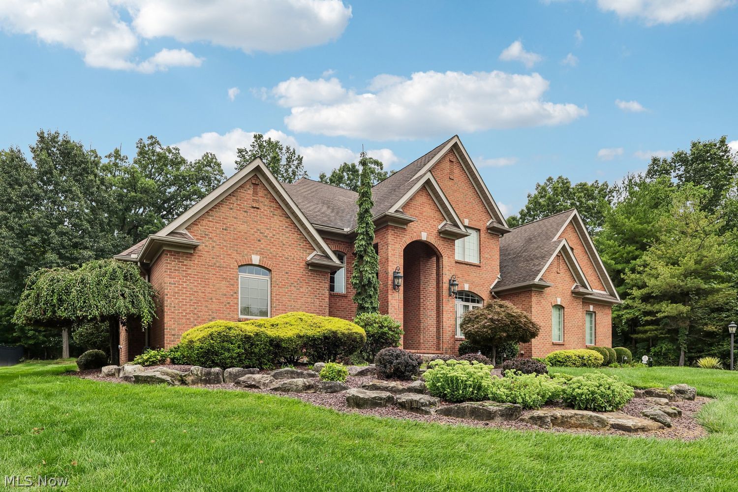 6836 Kyle Ridge Pointe Canfield, OH 44406 - Photo 1 of 45 Brick, plush landscaping, arched windows, lamp post, peaked gables