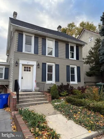 a front view of a house with garden and porch