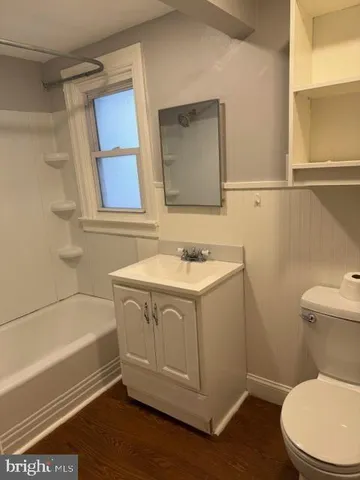 a kitchen with wooden floors and white appliances
