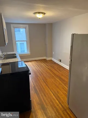 a view of empty room with window and fireplace