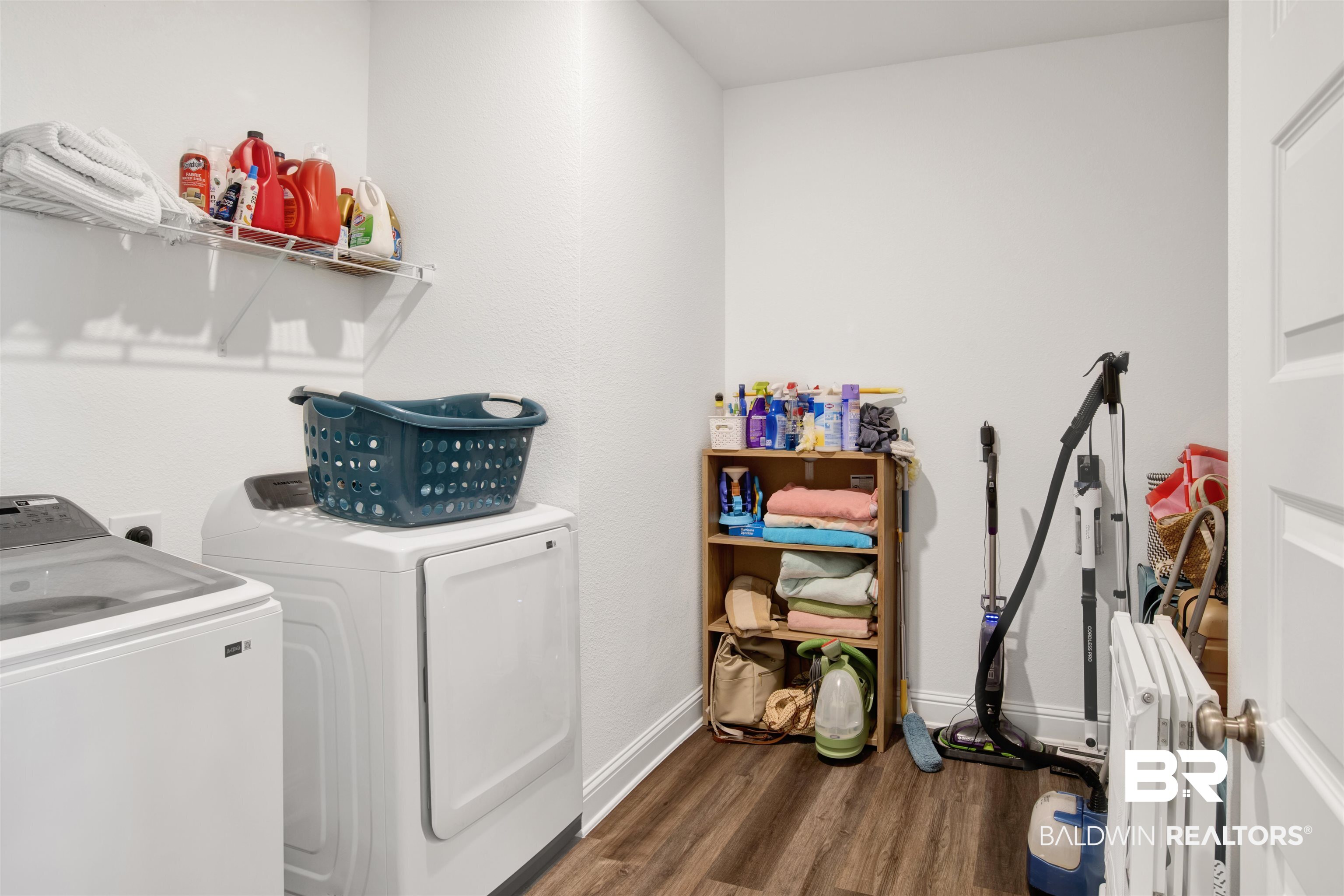 594 Shepard Street Gulf Shores, AL 36542 - Photo 14 of 51 Laundry room featuring dark wood-style flooring and washer and clothes dryer