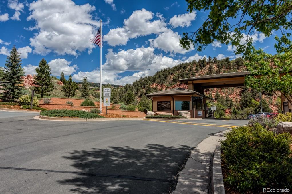 3455 Black Canyon Road Colorado Springs, CO 80904 - Photo 19 of 21 a front view of a house with a yard and garage