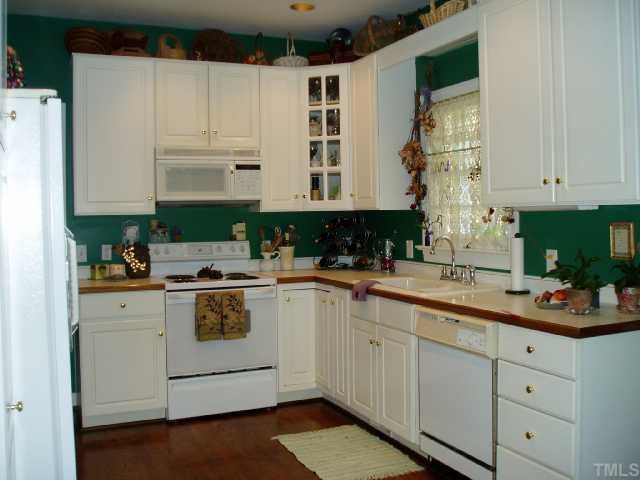 12000 Peed Road Raleigh, NC 27614 - Photo 8 of 12 a kitchen with cabinets appliances a sink and a counter