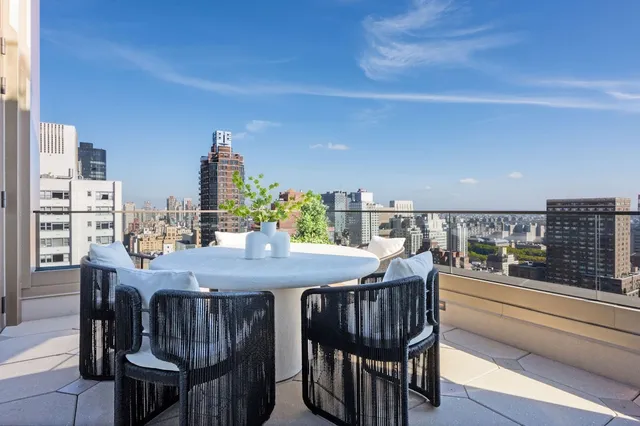 a living room with furniture and large windows