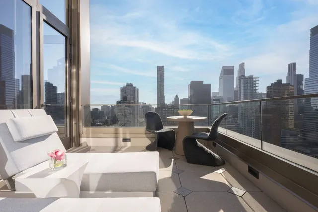 a bedroom with bed and glass windows