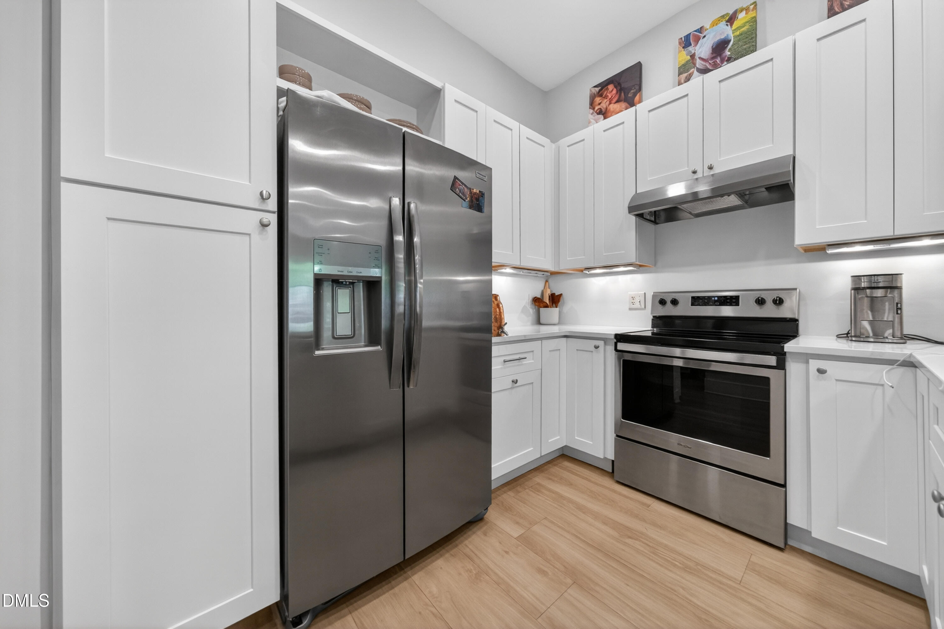 444 South Blount Street, Unit 111 Raleigh, NC 27601 - Photo 21 of 40 a kitchen with stainless steel appliances cabinets a sink and a counter space