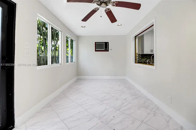 a view of a hallway with wooden floor and a mirror