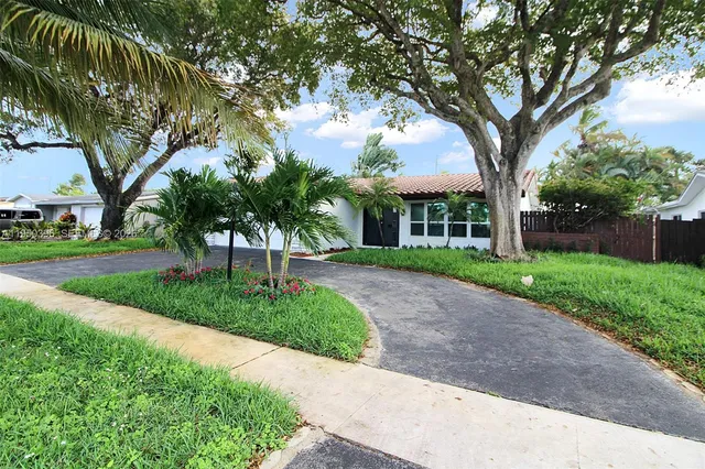 a view of a house with a tree in the background