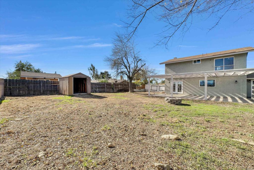 547 North Fillmore Avenue Rialto, CA 92376 - Photo 13 of 30 a view of house with backyard and trees in the background
