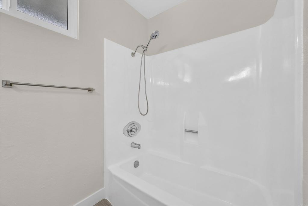547 North Fillmore Avenue Rialto, CA 92376 - Photo 17 of 30 a bathroom with a bathtub and a shower