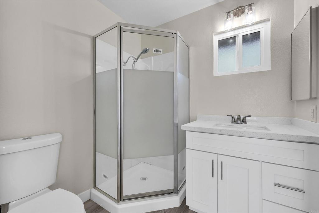 547 North Fillmore Avenue Rialto, CA 92376 - Photo 19 of 30 a bathroom with a shower sink and mirror