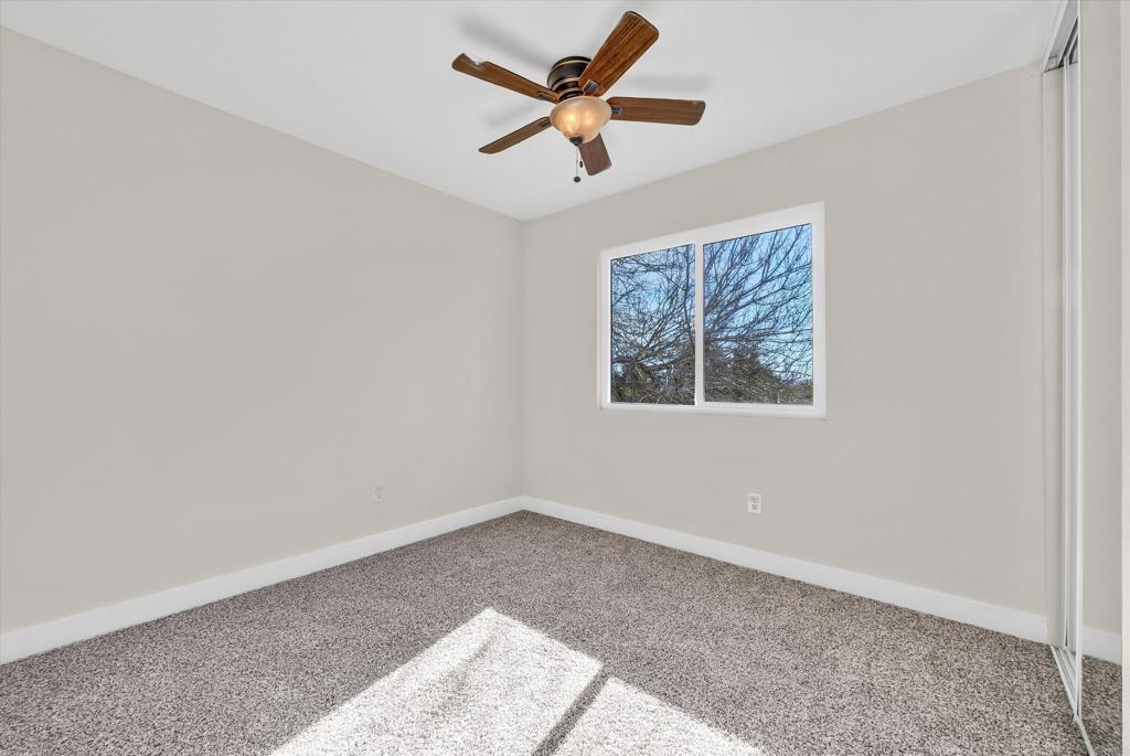 547 North Fillmore Avenue Rialto, CA 92376 - Photo 21 of 30 an empty room with a window and a ceiling fan