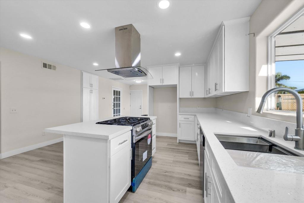 547 North Fillmore Avenue Rialto, CA 92376 - Photo 26 of 30 a kitchen with a stove sink and cabinets