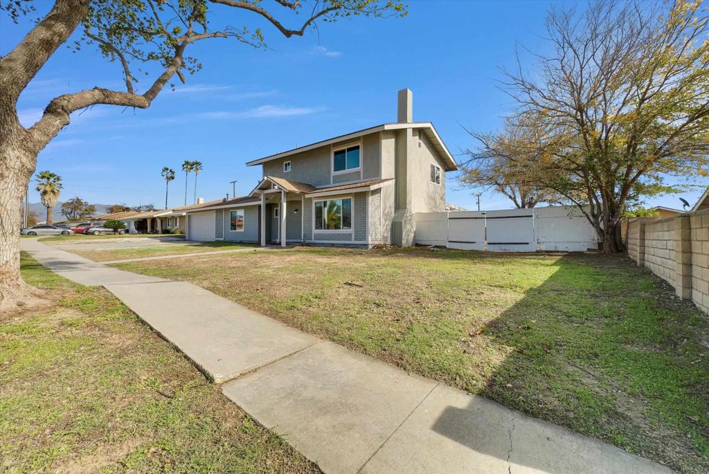 547 North Fillmore Avenue Rialto, CA 92376 - Photo 29 of 30 a front view of a house with a yard