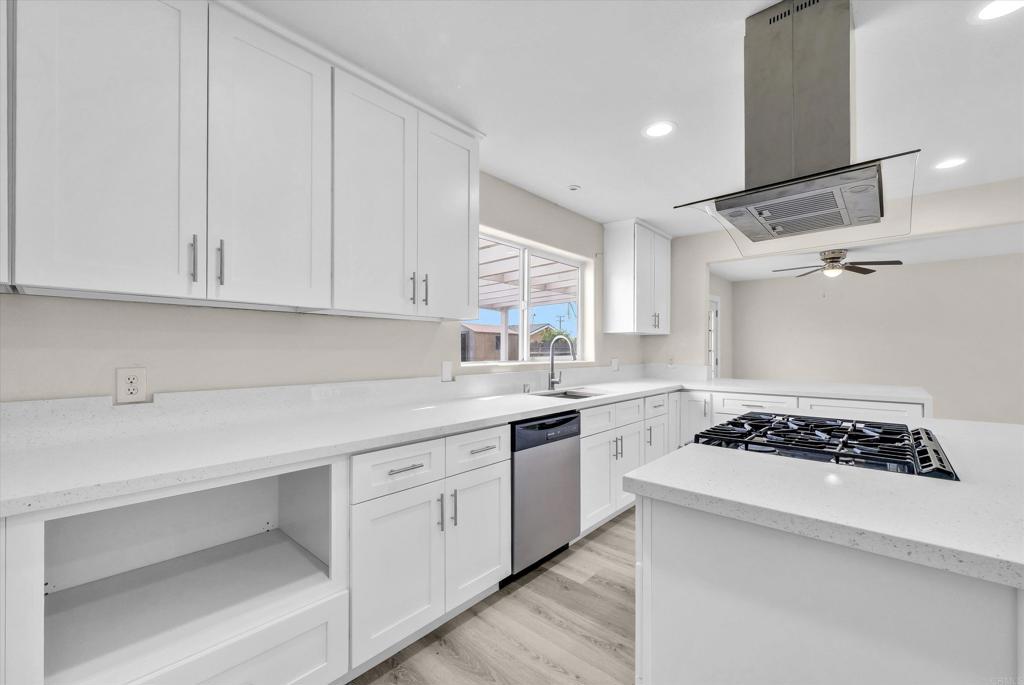 547 North Fillmore Avenue Rialto, CA 92376 - Photo 3 of 30 a kitchen with white cabinets and appliances