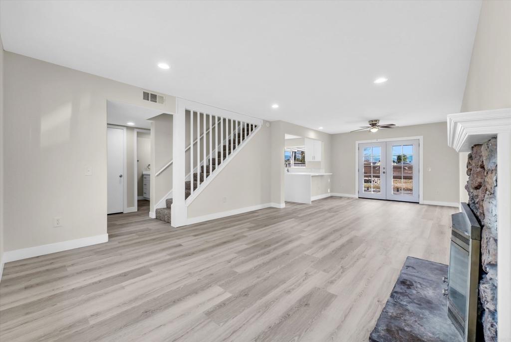 547 North Fillmore Avenue Rialto, CA 92376 - Photo 4 of 30 an empty room with wooden floor fireplace and windows