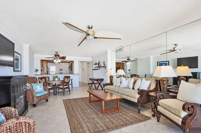 a living room with furniture a fireplace and a flat screen tv