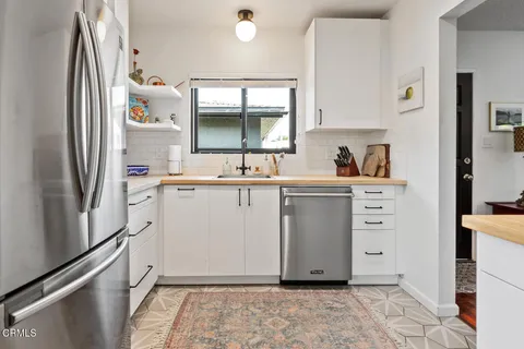 a room with cabinets a washer and dryer