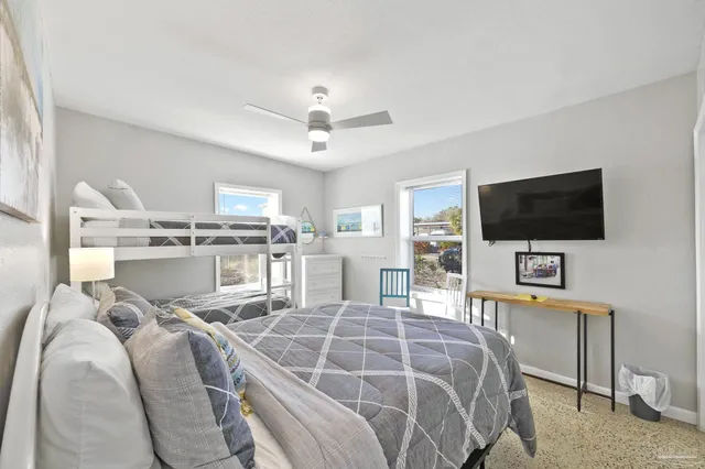 a bed room with a bed and a television