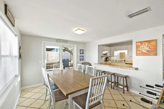 a dining room with furniture and a flat screen tv