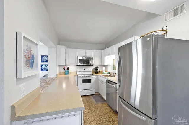 a kitchen with a sink stove top oven and cabinets