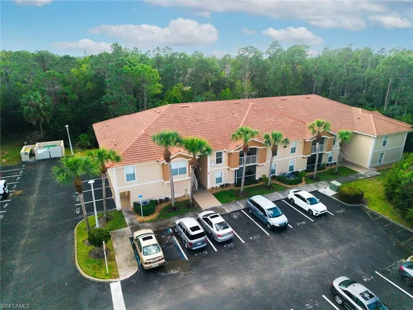 an aerial view of a house with garden space and street view