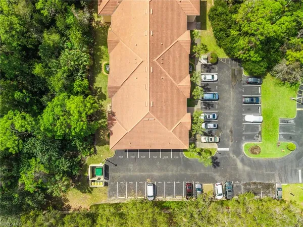 an aerial view of a residential apartment building with a yard and plants