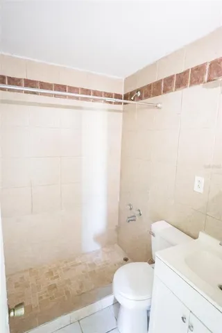 a bathroom with a shower and a toilet