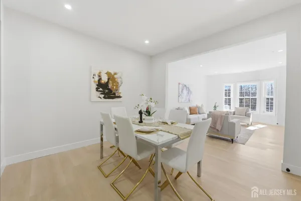 a dining room with furniture and wooden floor
