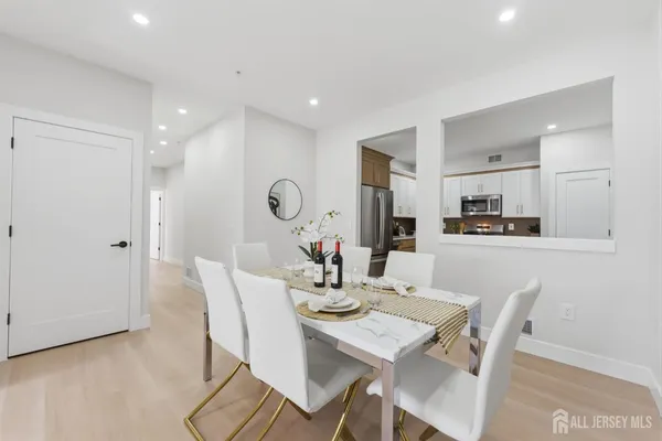a view of a dining room with furniture and wooden floor