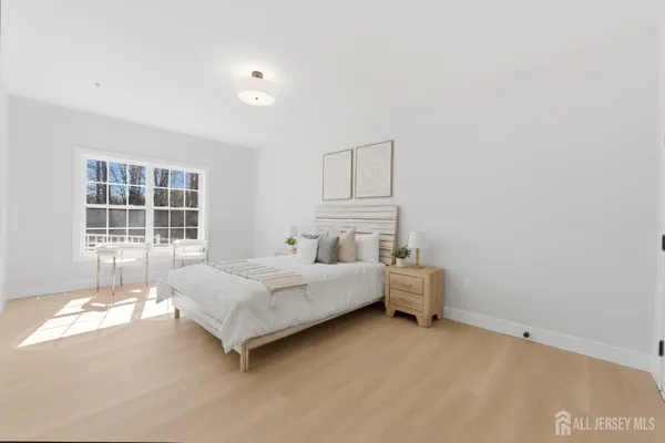 a spacious bedroom with a bed and a window