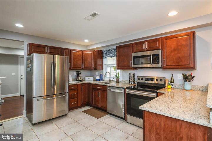 814 Foxwell Road Joppa, MD 21085 - Photo 2 of 23 a kitchen with stainless steel appliances granite countertop a refrigerator stove top oven and sink