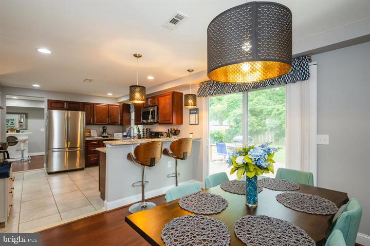 814 Foxwell Road Joppa, MD 21085 - Photo 6 of 23 a dining room filled chandelier and kitchen view
