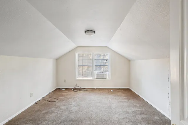 an empty room with a empty space and windows