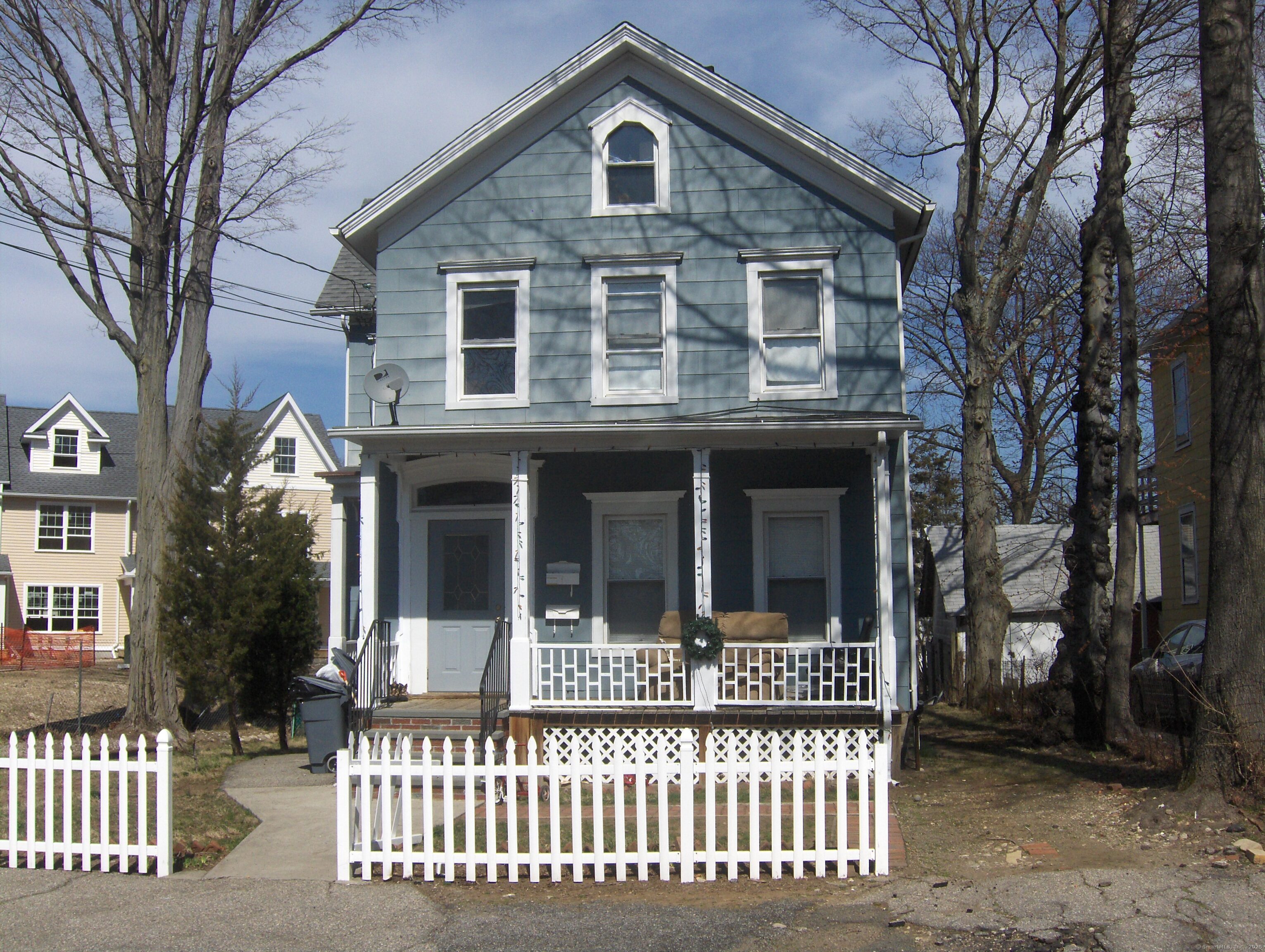 2 1/2 Jefferson Street, Unit 1 Norwalk, CT 06851 - Photo 1 of 1 a view of a house with a small yard and a large tree